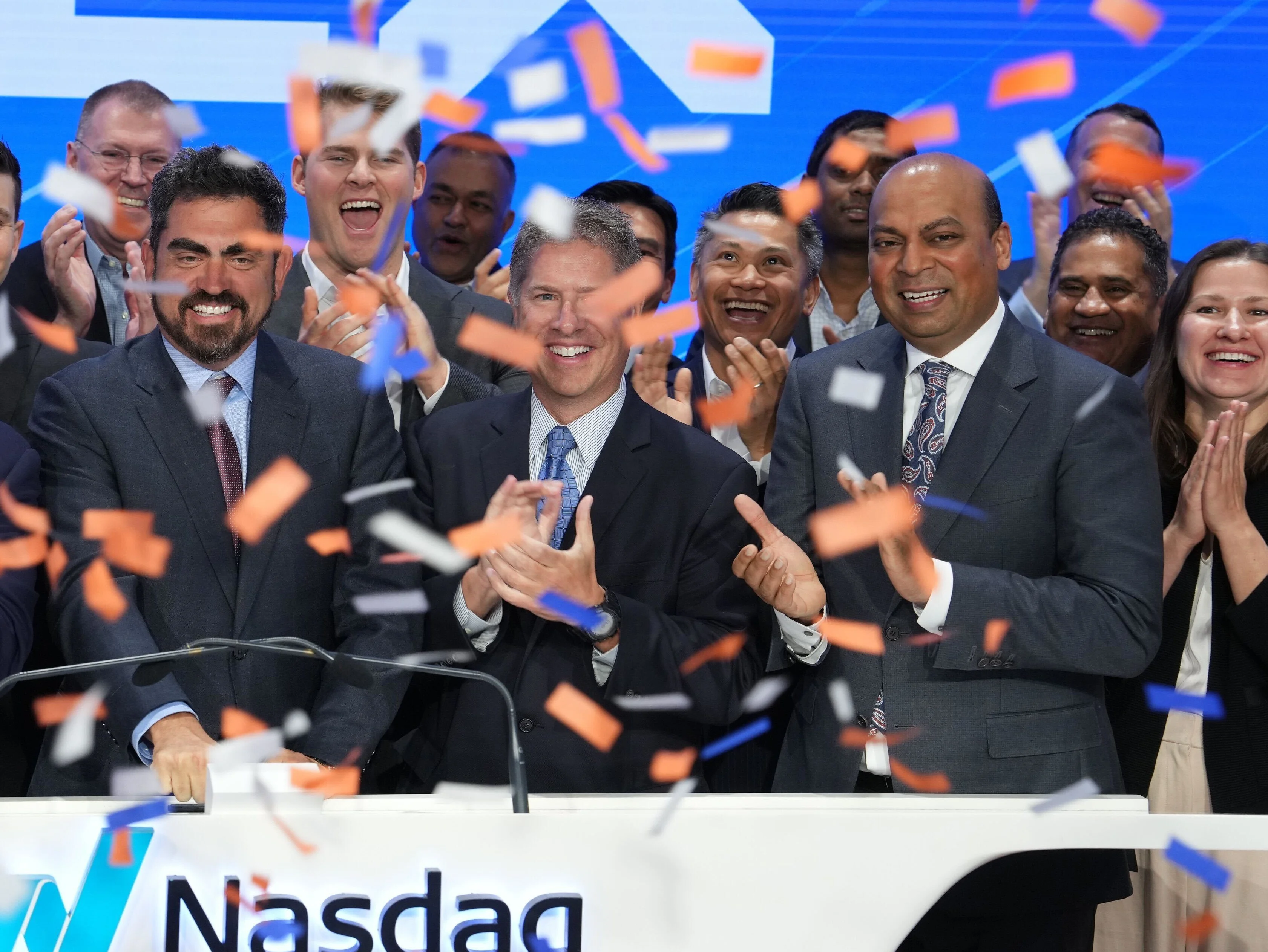 Greg King ringing the Nasdaq bell, surrounded by his team and confetti